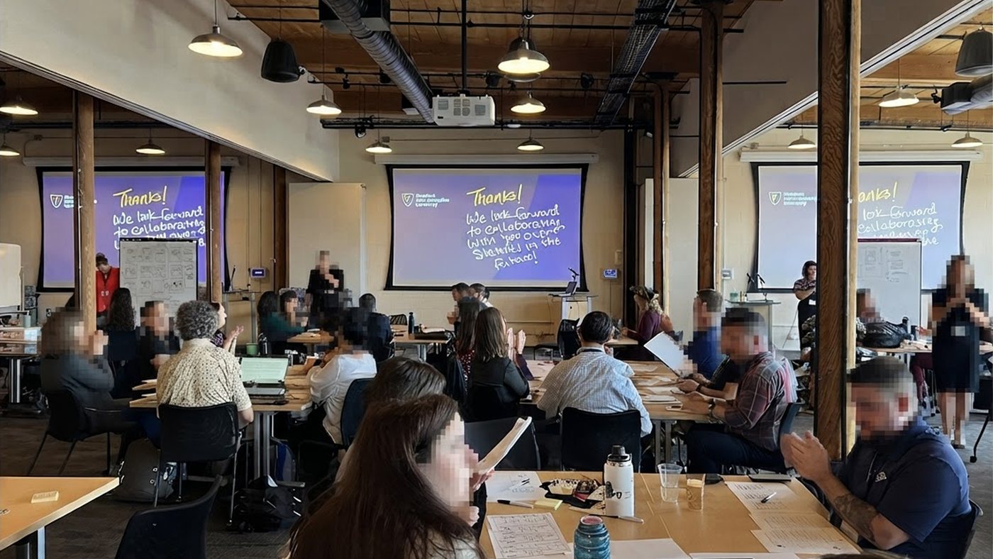 A large multi-room workshop space, participants applauding, closing slides reading Thanks, we look forward to collaborating with you, faces blurred